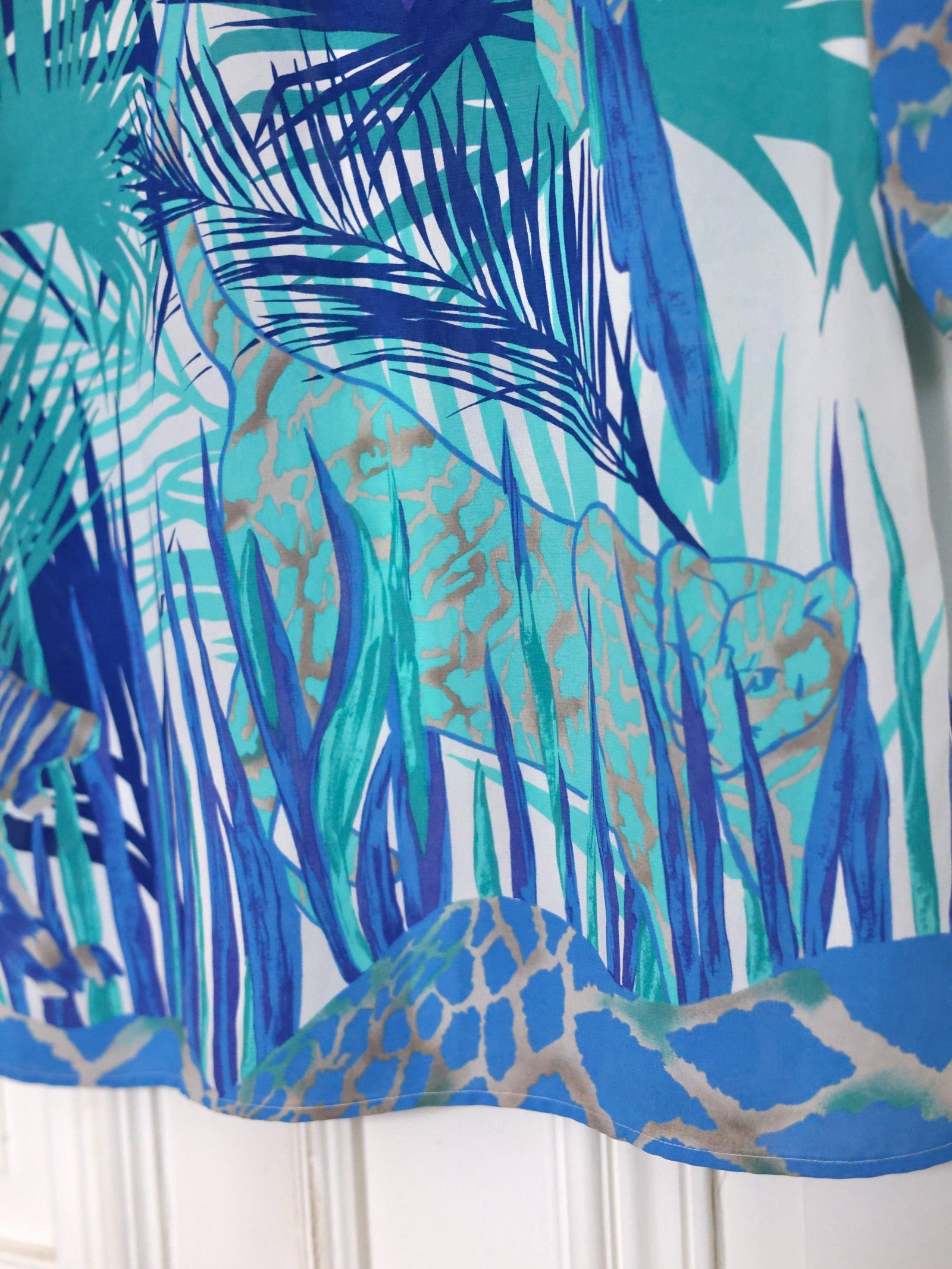 Ce chemisier vintage Louis Féraud 80s à imprimé jungle turquoise est une pièce emblématique des années 80, facile à porter avec un jean, un pantalon tailoring ou une silhouette plus rock en cuir noir. Boutique mode vintage, blog mode, Pau Wu, Pauwu